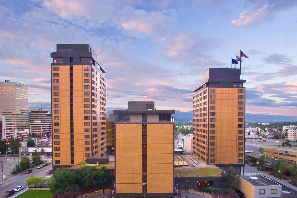 a group of tall buildings with flags on top