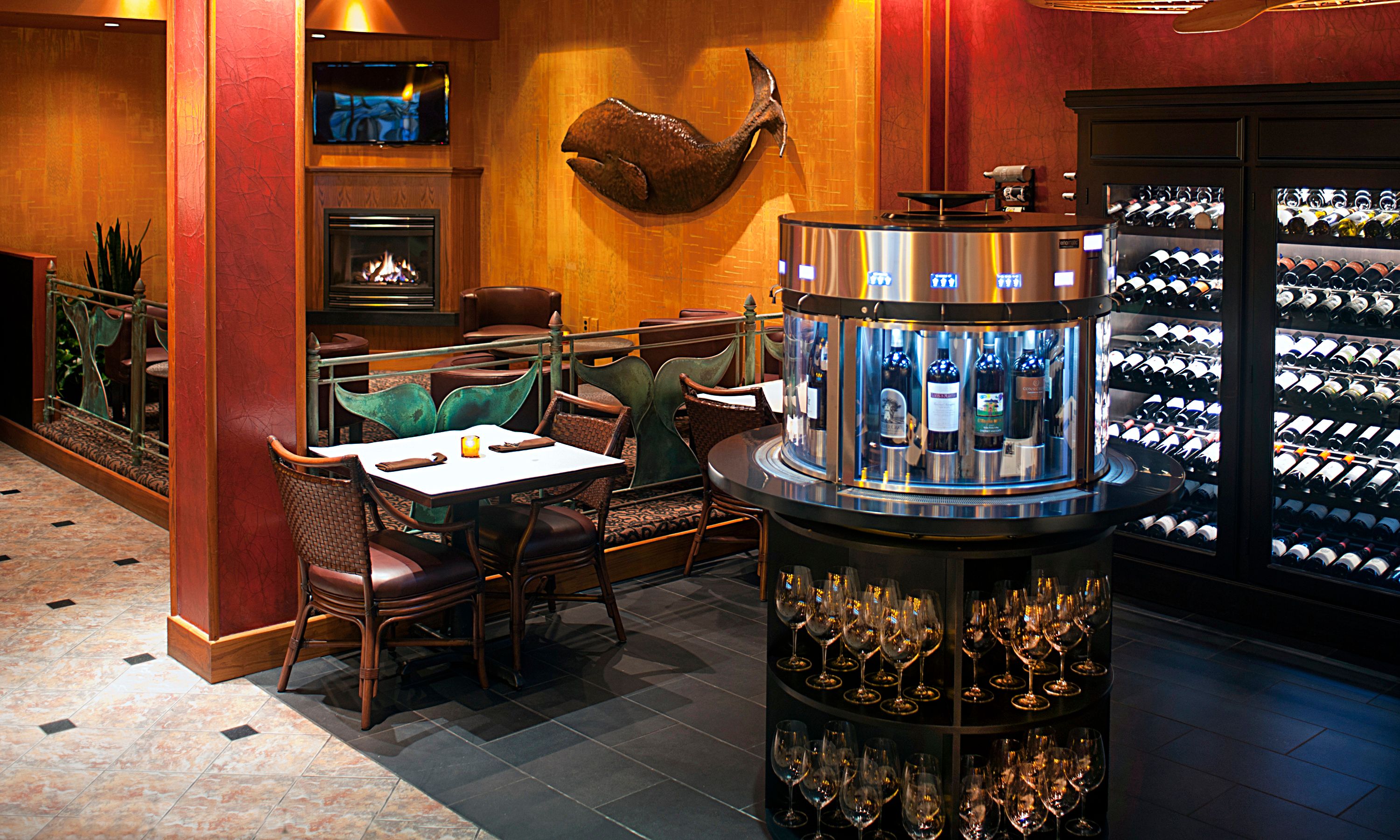 a room with a table and chairs and a wine rack