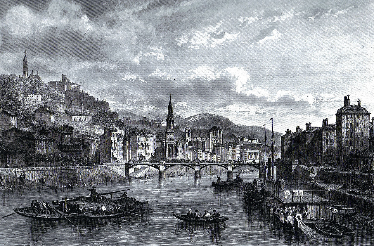 a river with boats and a bridge