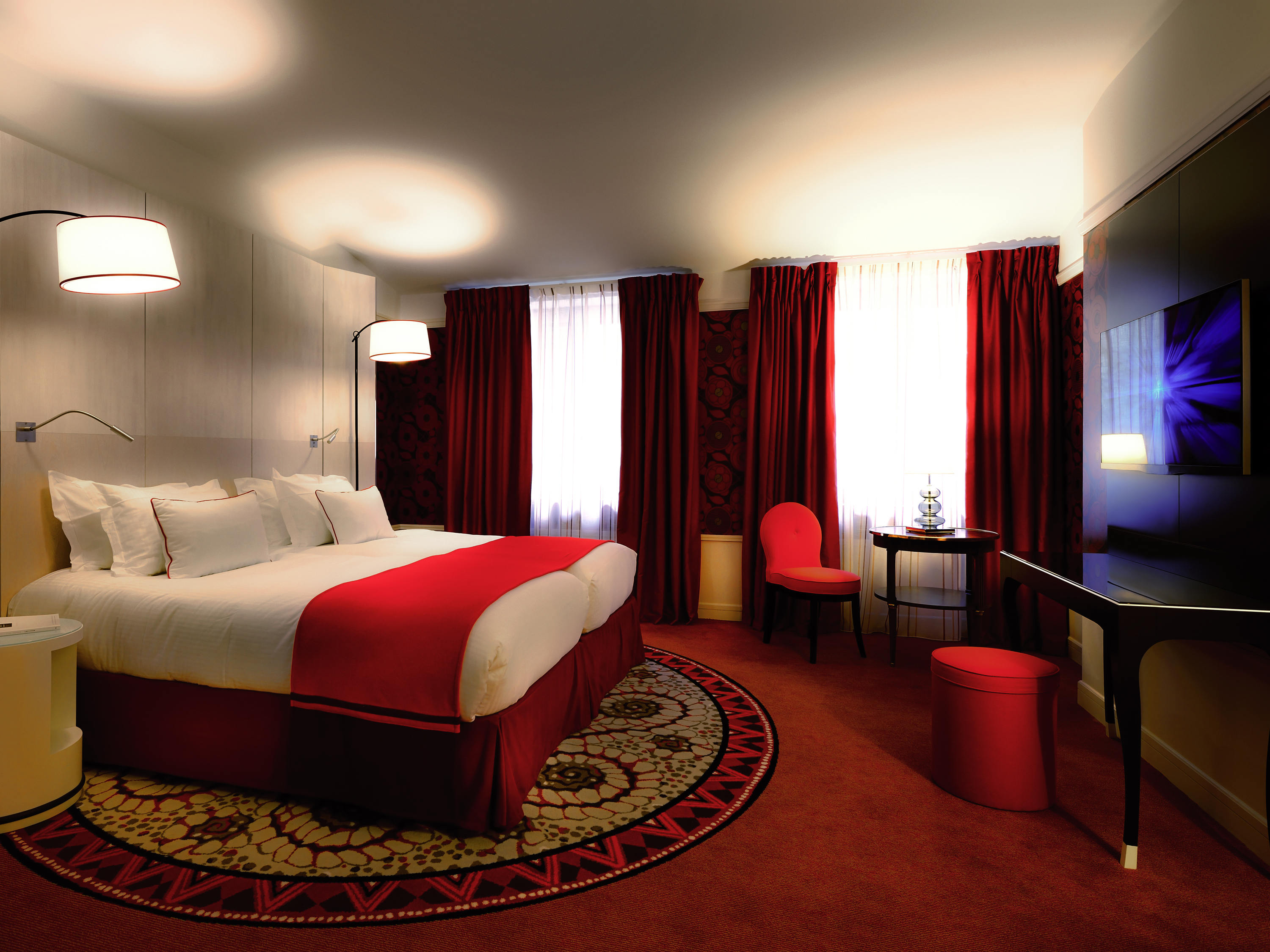 a room with a bed and a table and chairs
