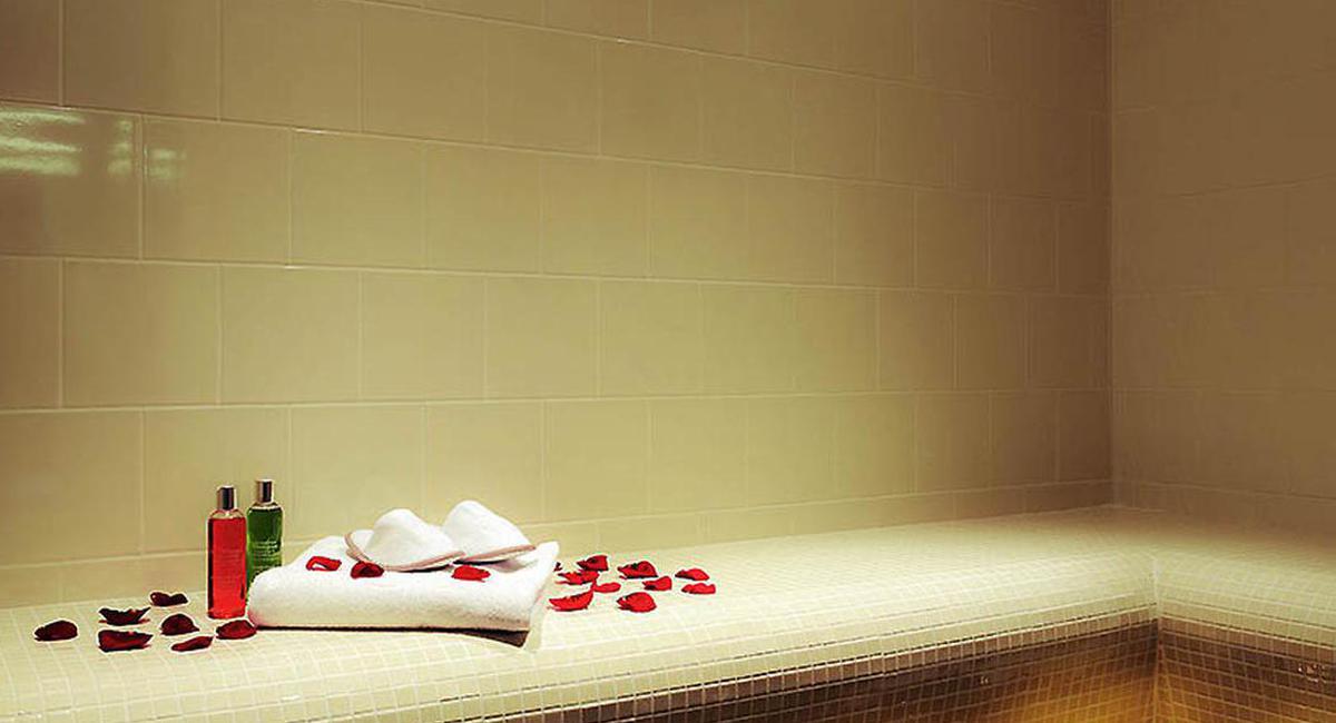 a towel and rose petals on a bench