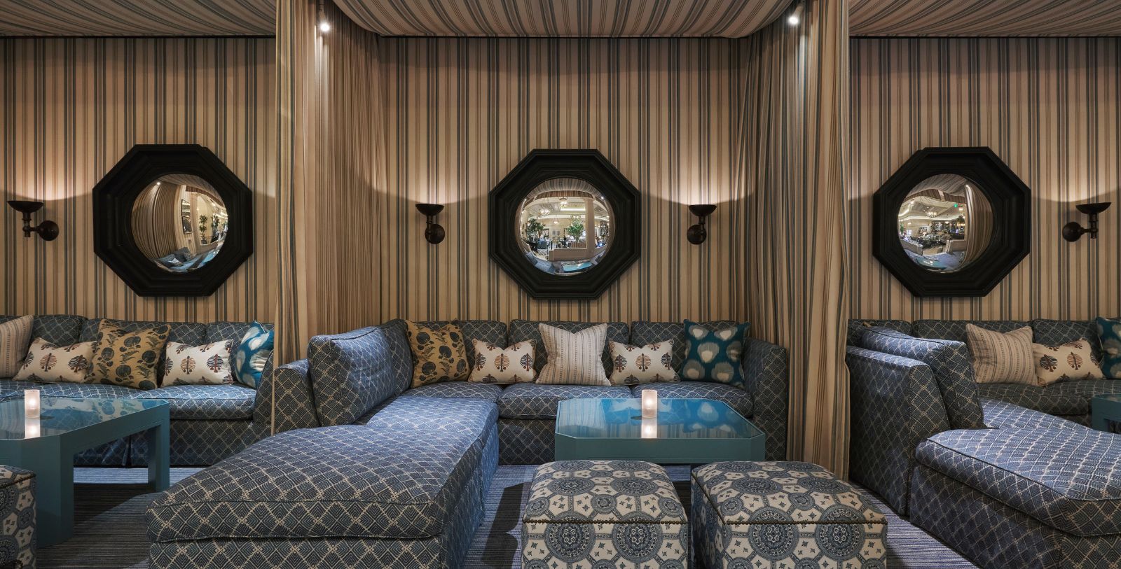 a couch with a round mirror on the wall