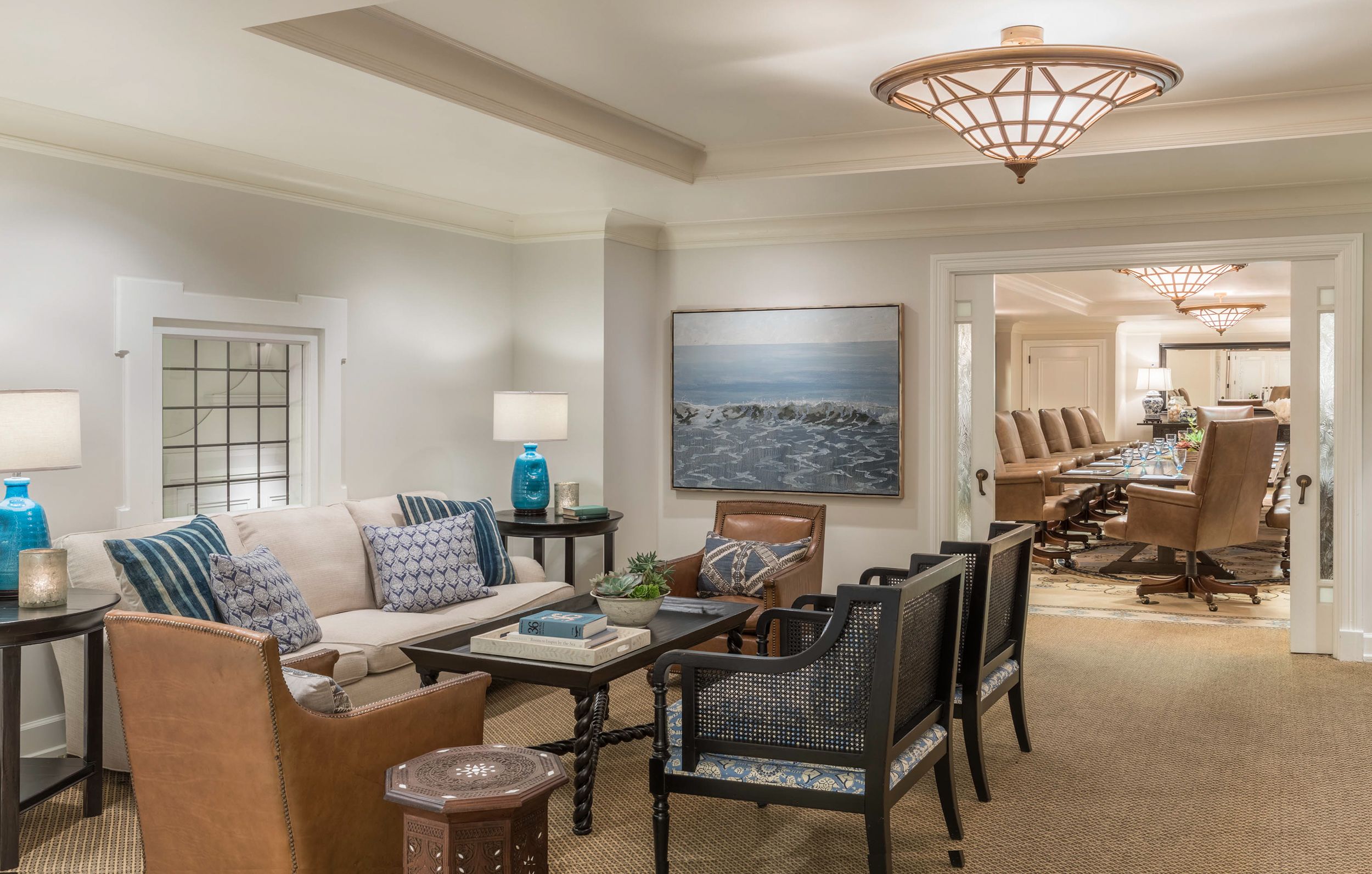 a room with a couch and chairs