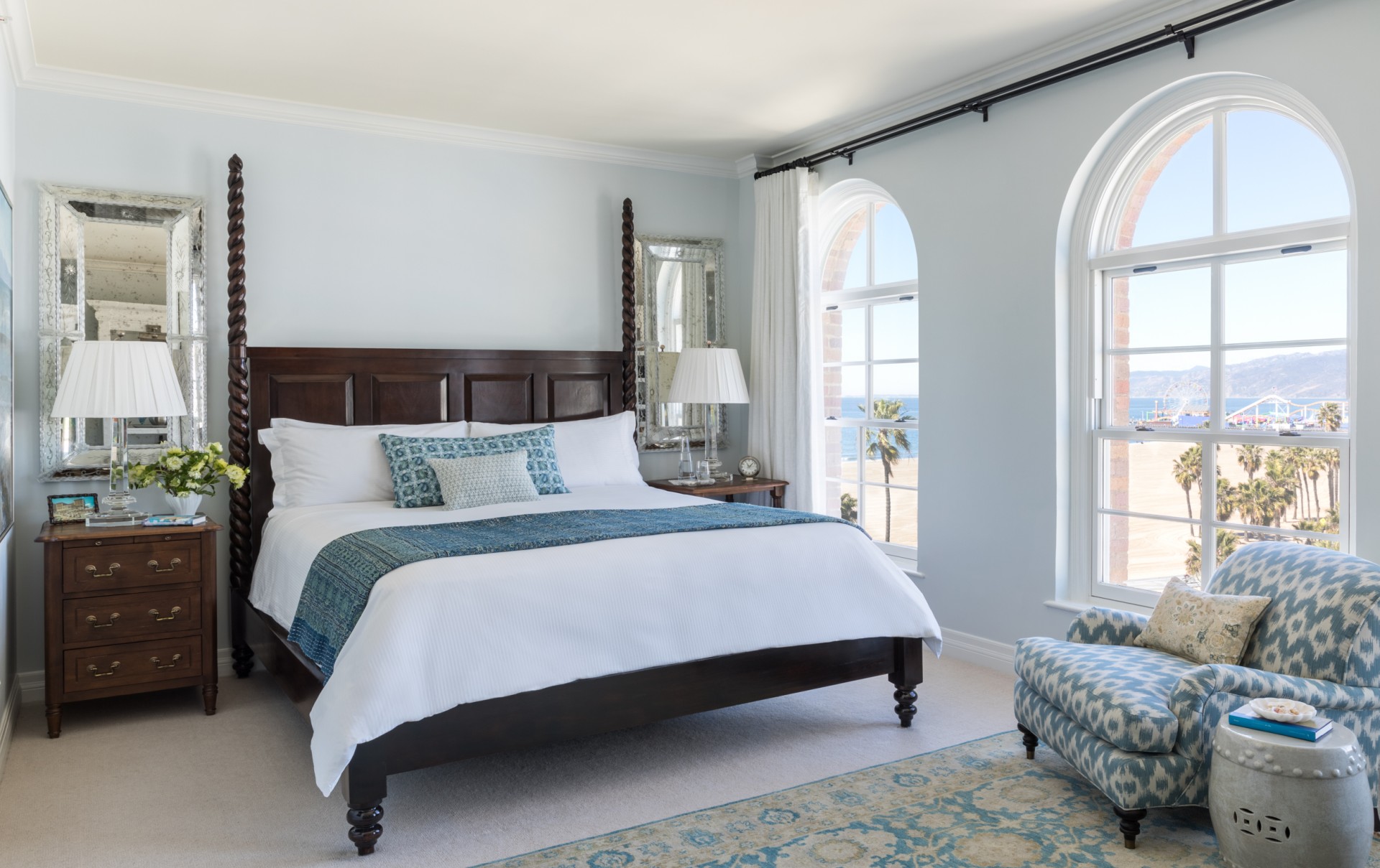 a bedroom with a bed and a mirror