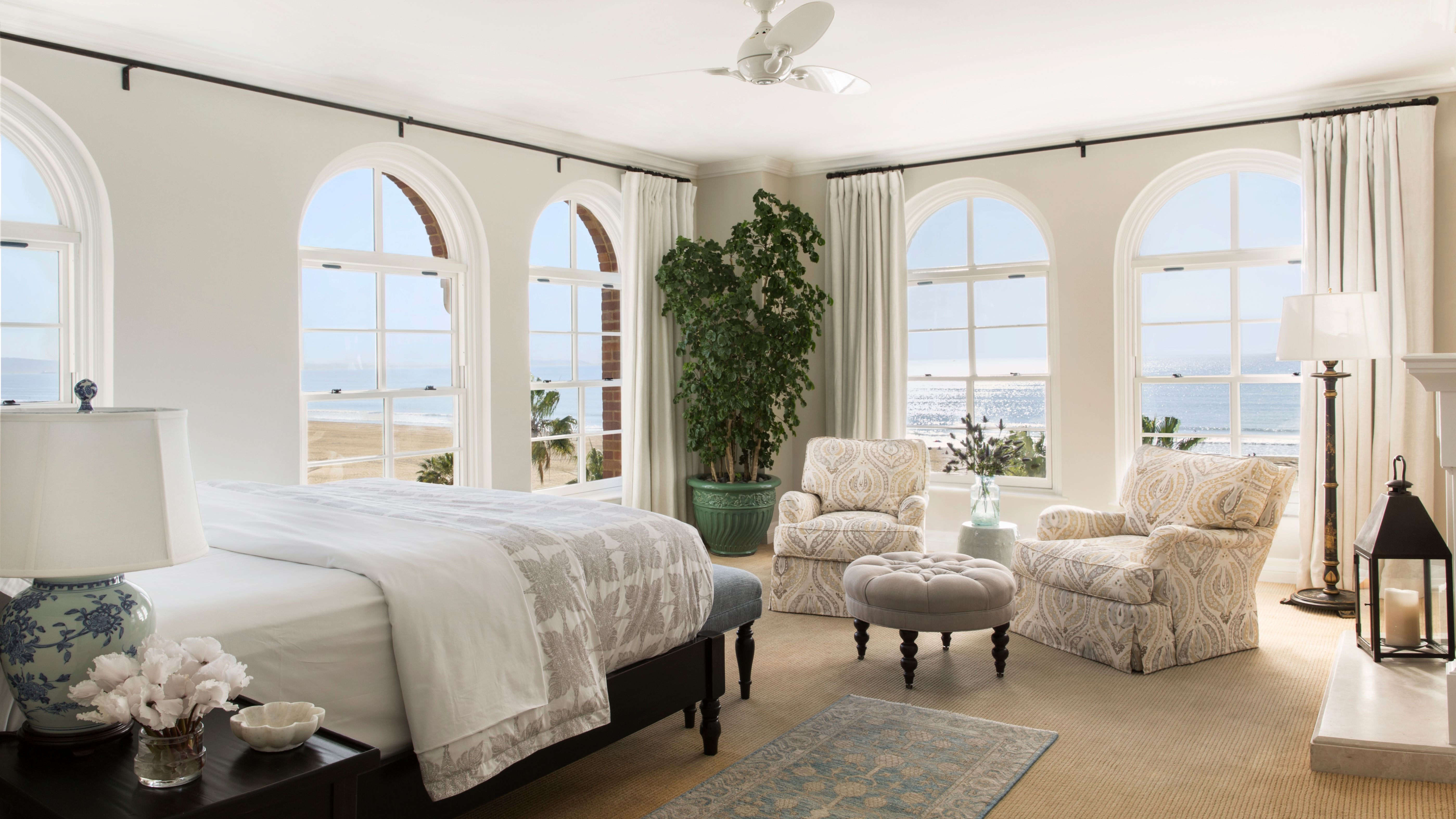 a bedroom with a large window and a large bed