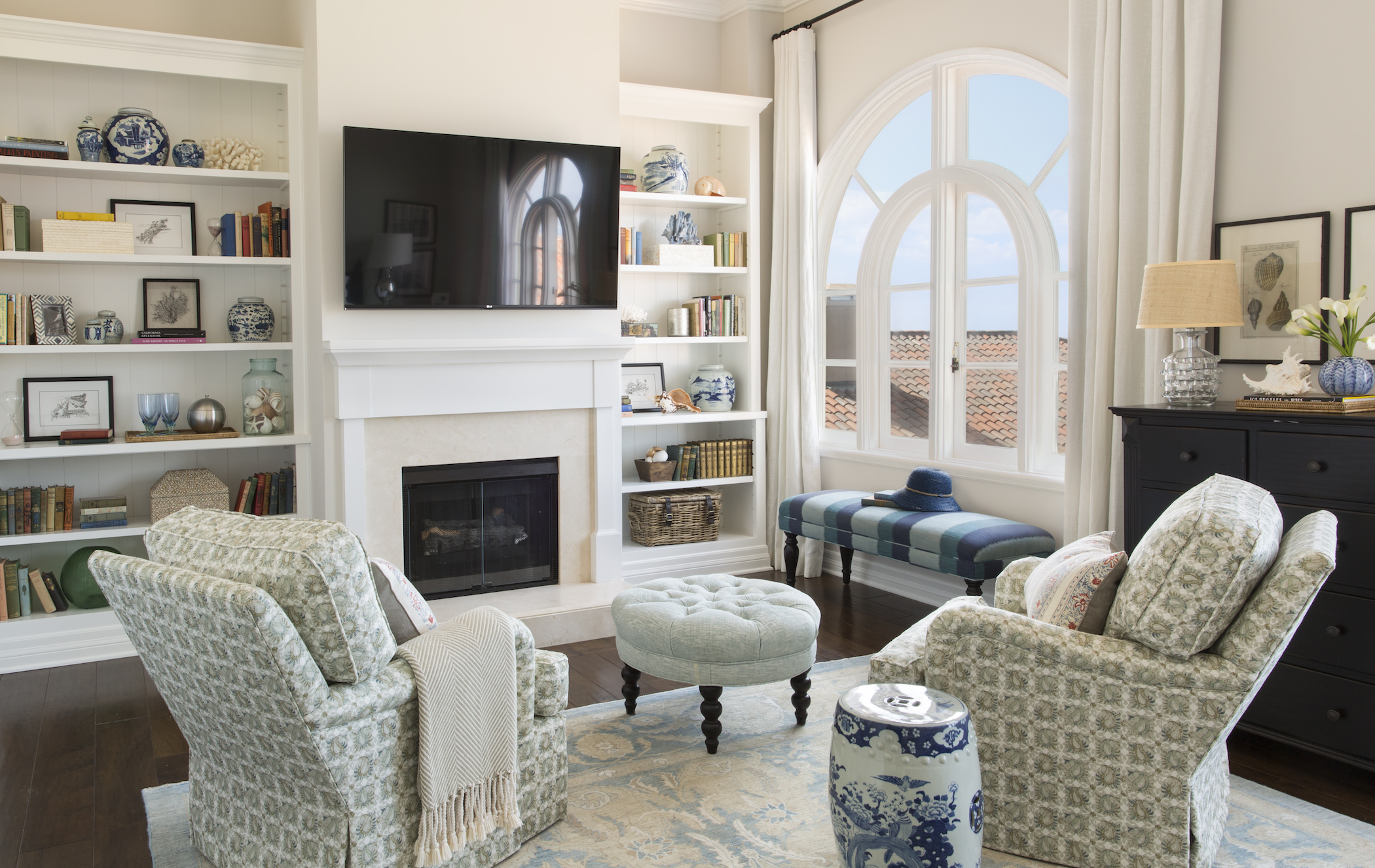 a living room with a fireplace and a tv