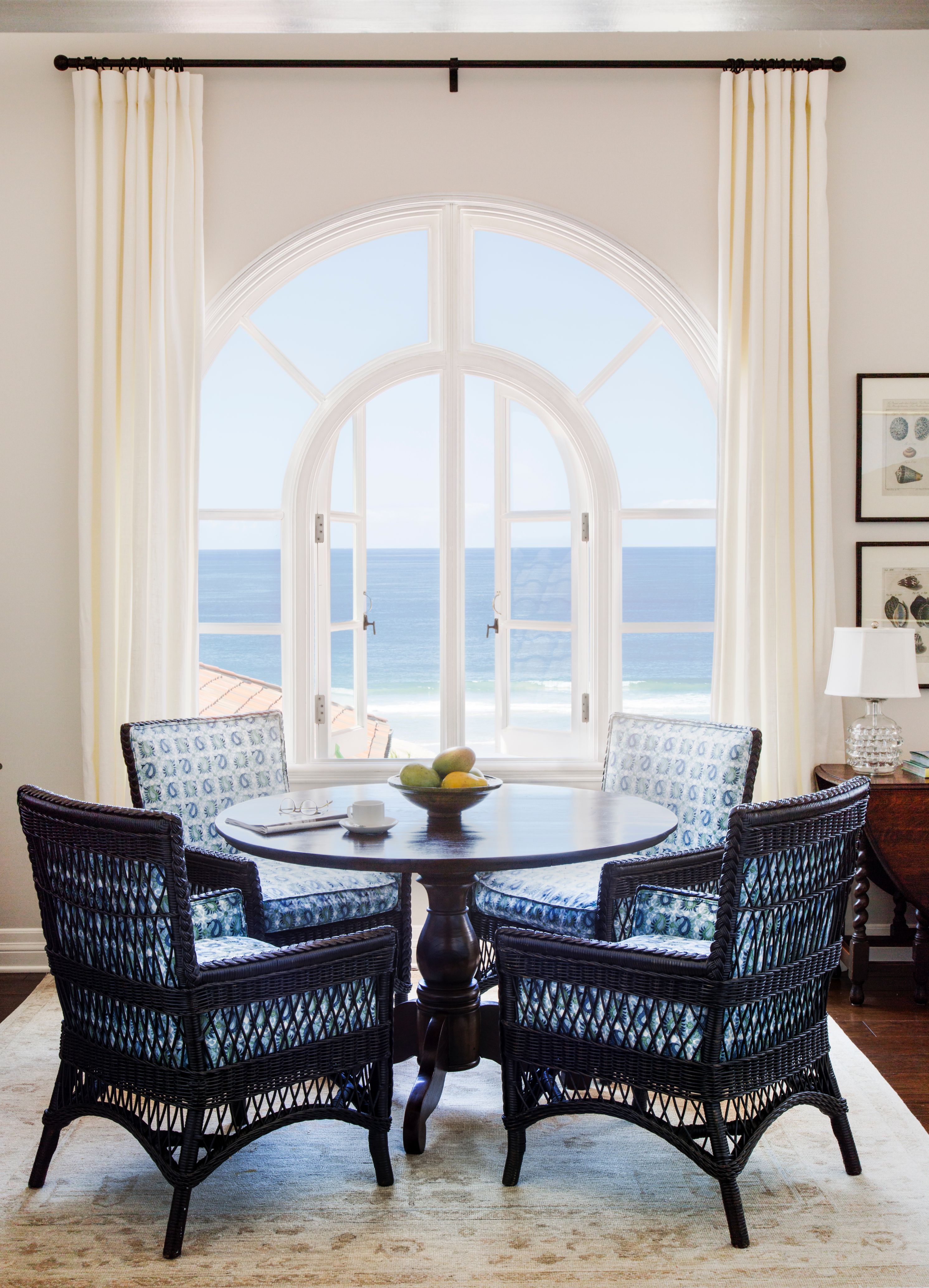 a room with a round table and chairs
