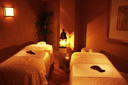 a massage room with two beds