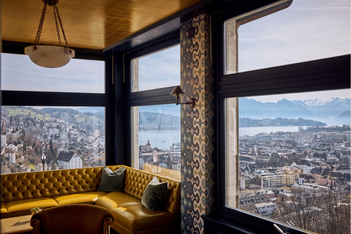 a room with a couch and a view of a city