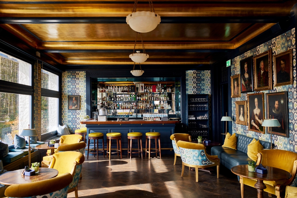 a room with a bar and chairs
