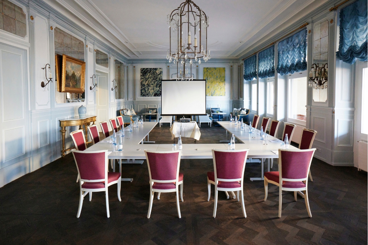 a room with a large table and chairs