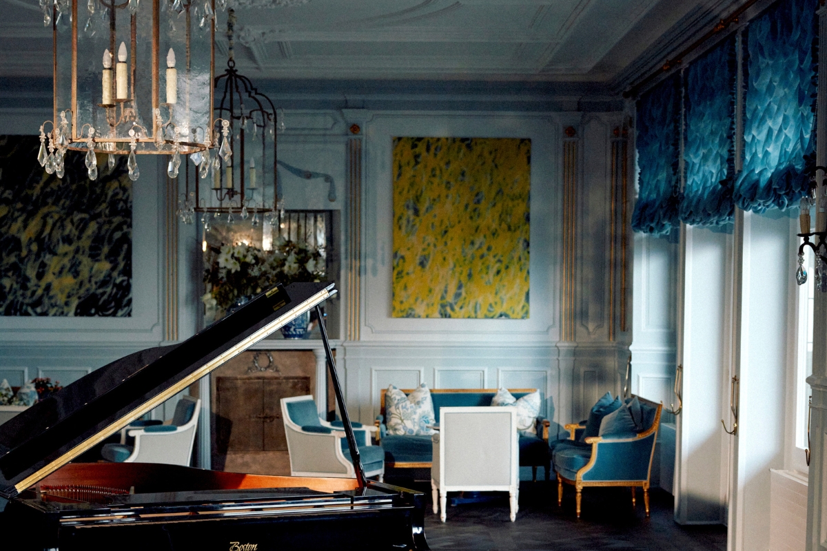 a room with a piano and couches