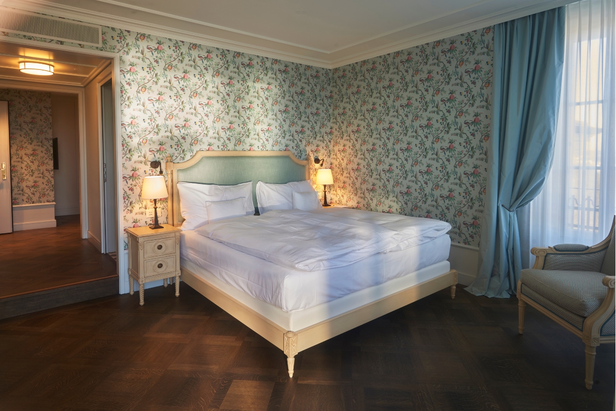 a bed with a lamp on the side