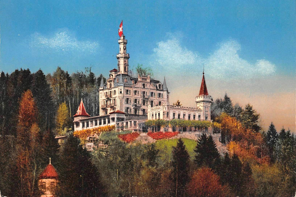 Vintage illustration of a grand fairytale-style castle nestled on a forested hilltop with autumn foliage, featuring pointed red towers and a tall central spire flying a Swiss flag against a blue sky.