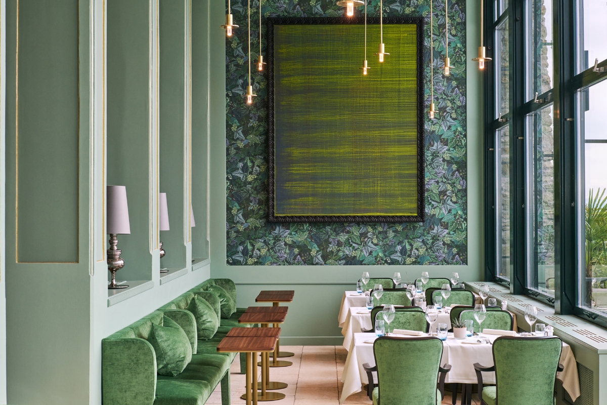 a room with green walls and a large framed picture