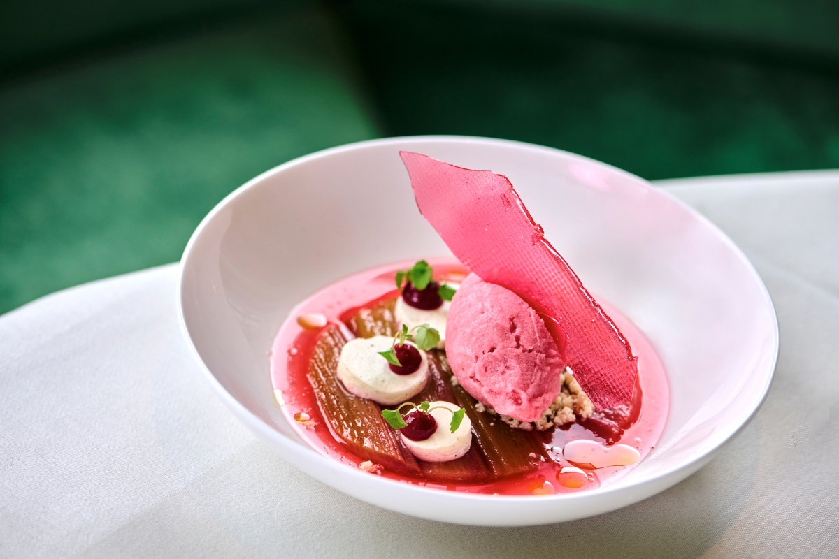 a bowl of dessert with a pink ice cream scoop