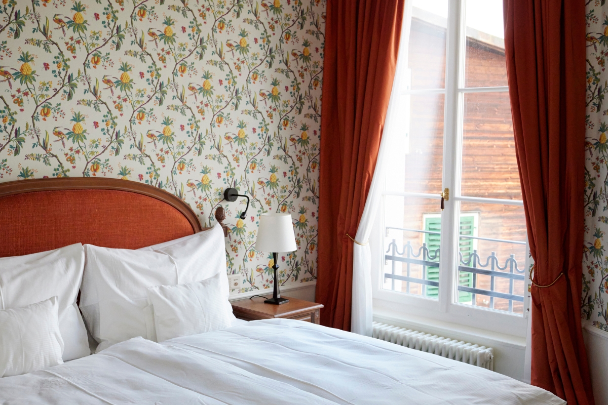 a bed with a lamp and a window