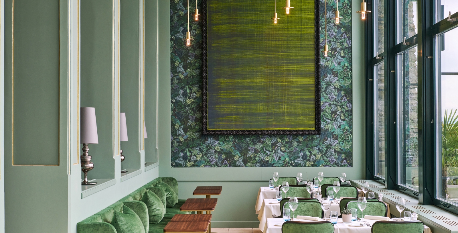 a room with green couches and tables