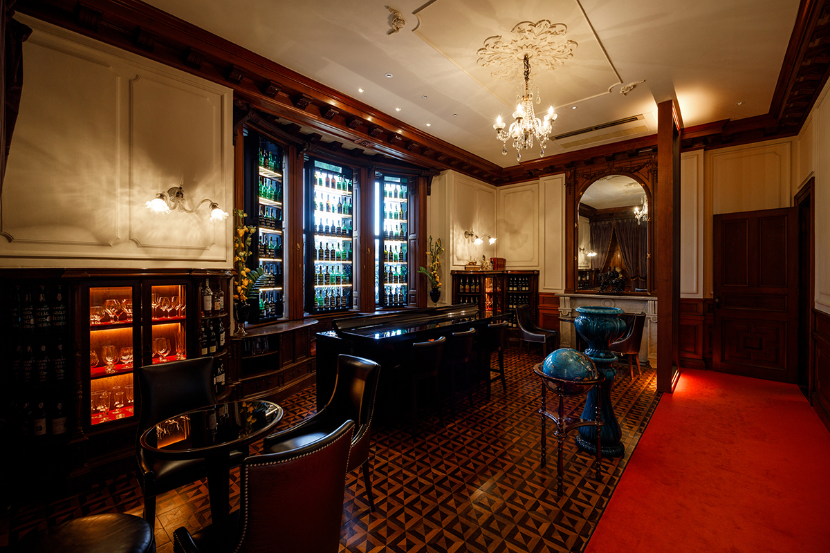 a room with a bar and a chandelier