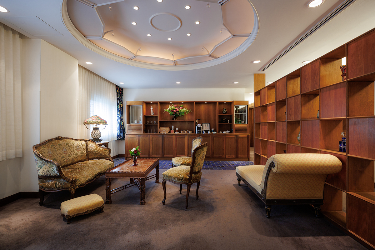 a room with a couch and chairs