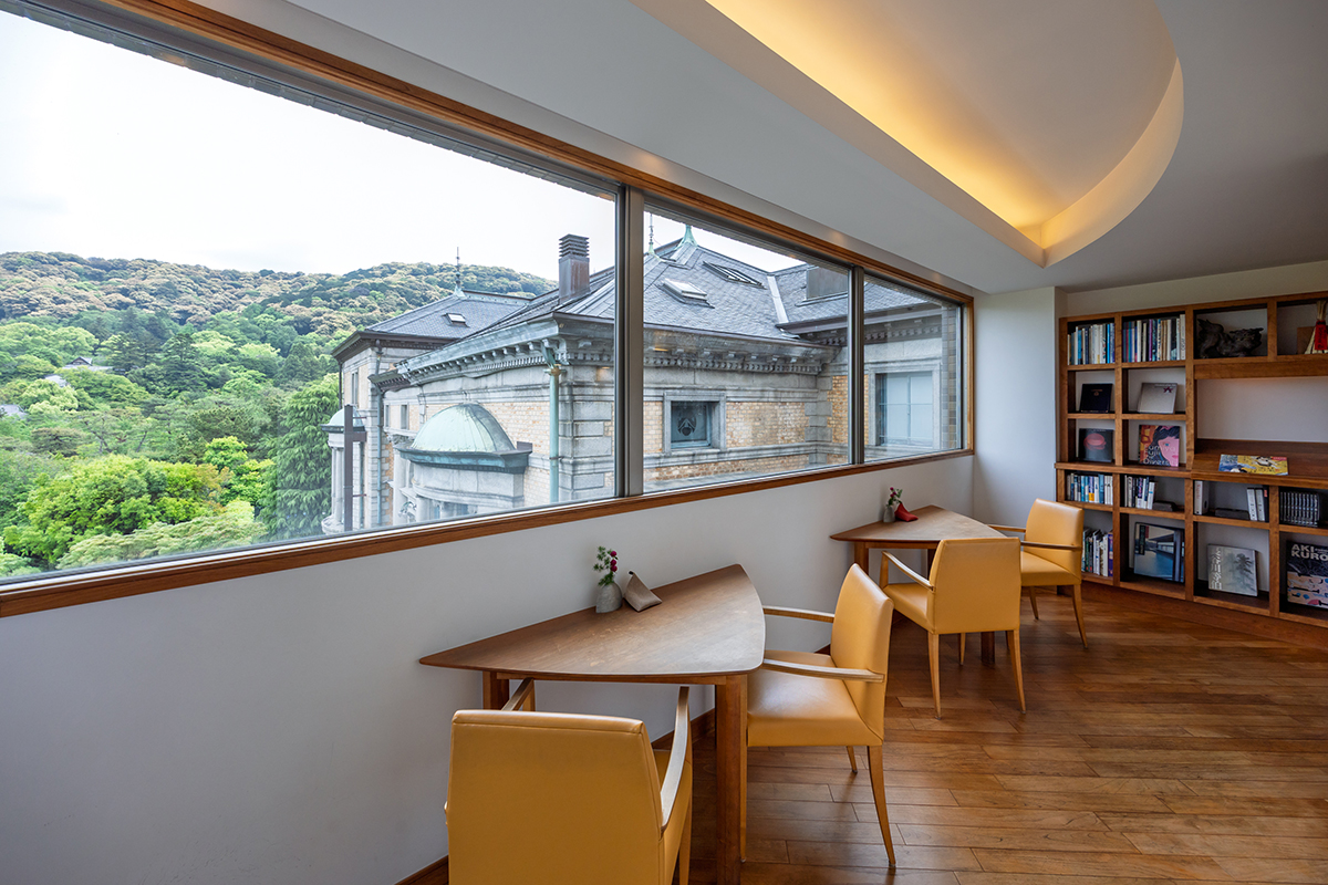 a room with a window and tables and chairs