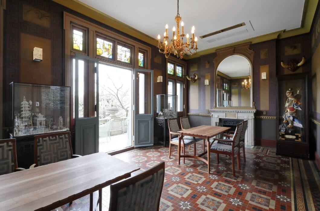 a room with a chandelier and chairs