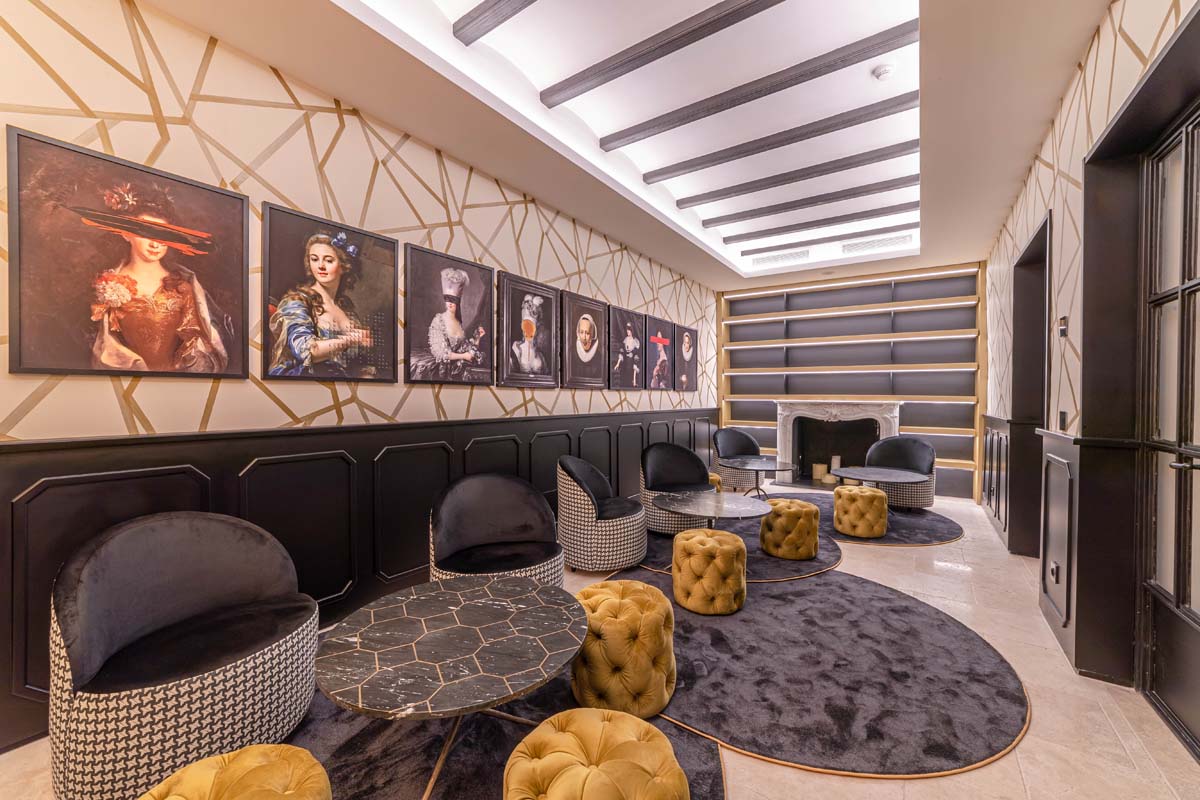 a room with a fireplace and art on the wall