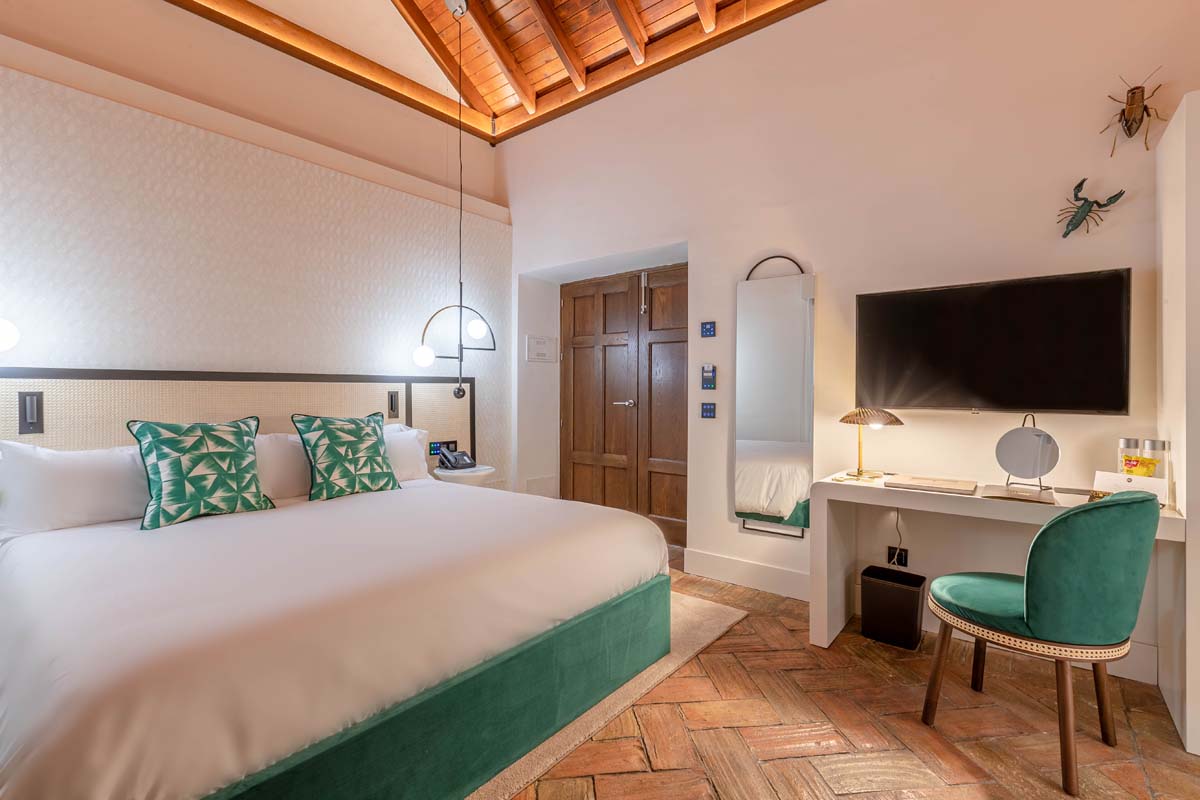 a room with a bed and a television