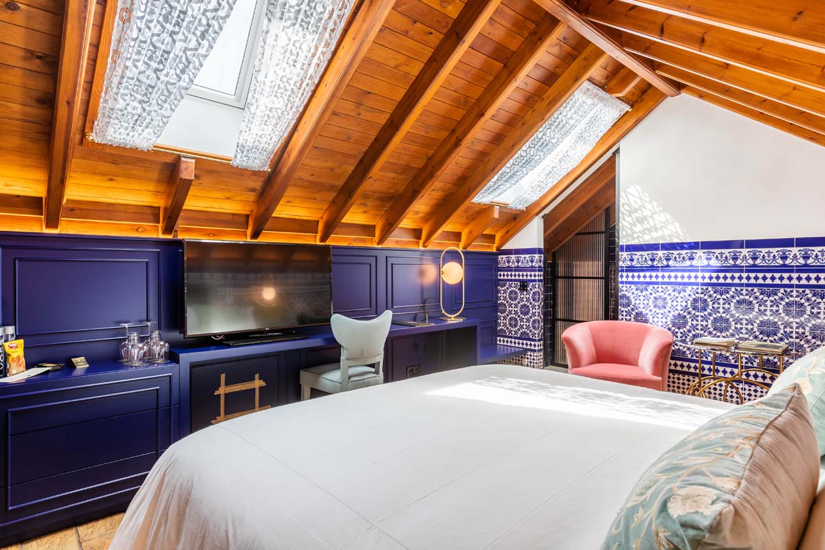 a bedroom with a tv and a bed