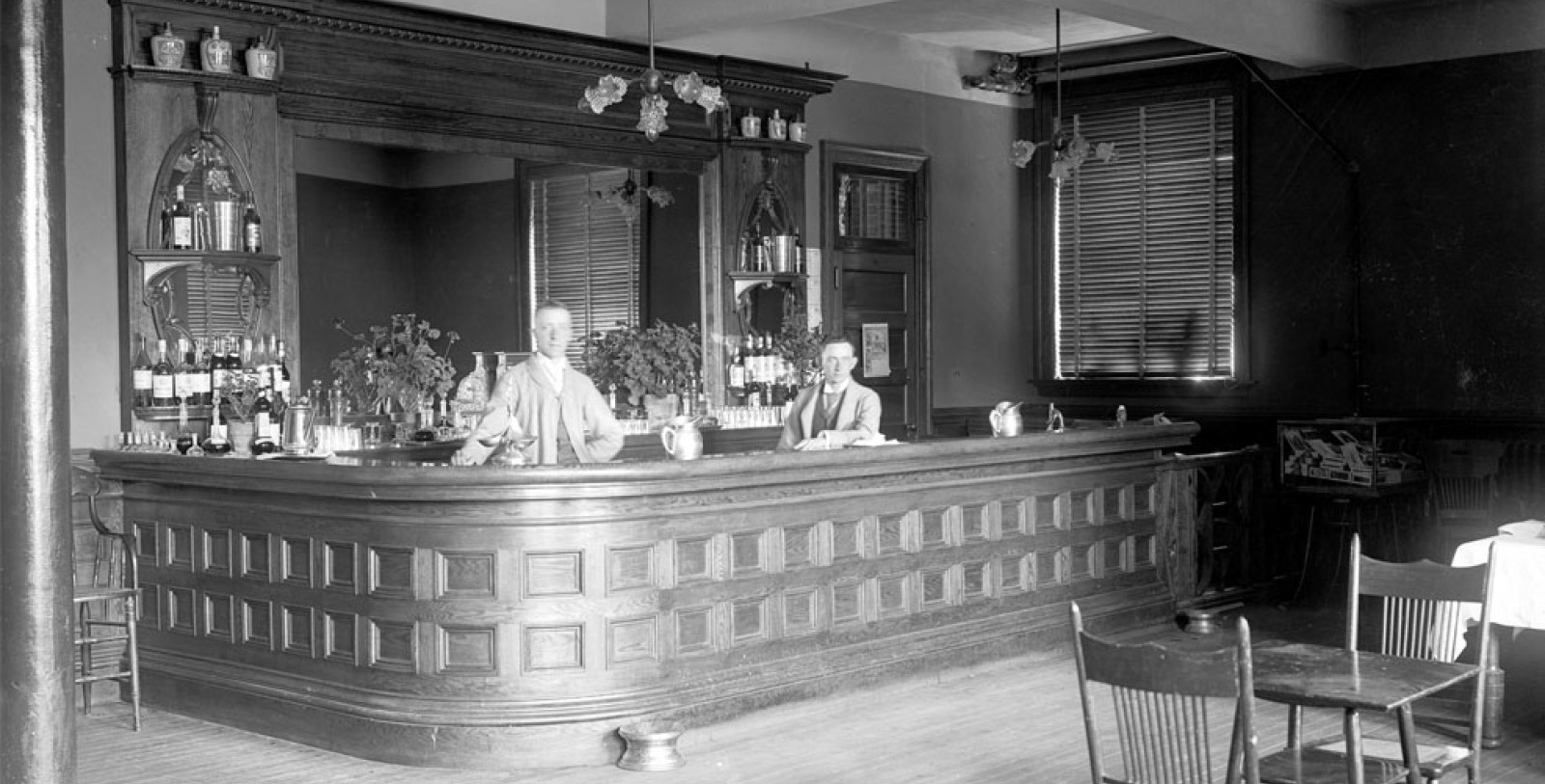 a man standing behind a bar