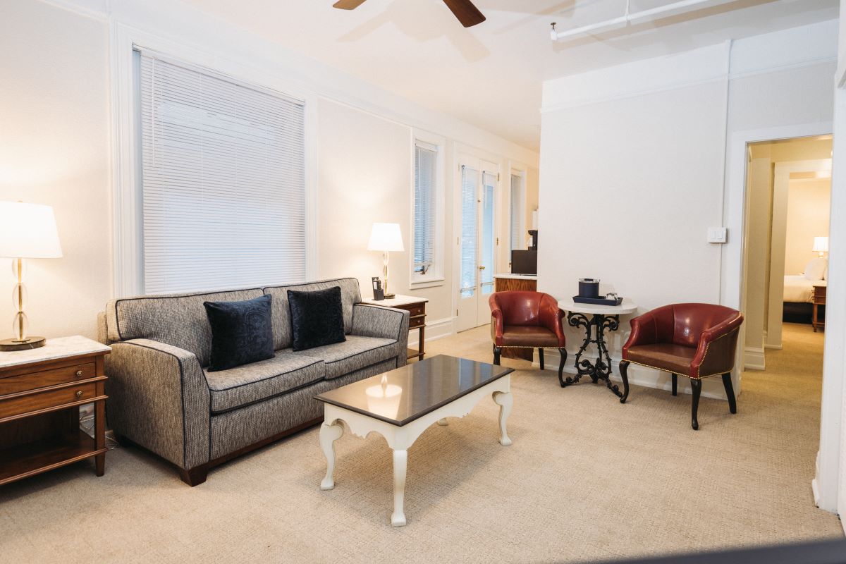 a living room with a couch and chairs
