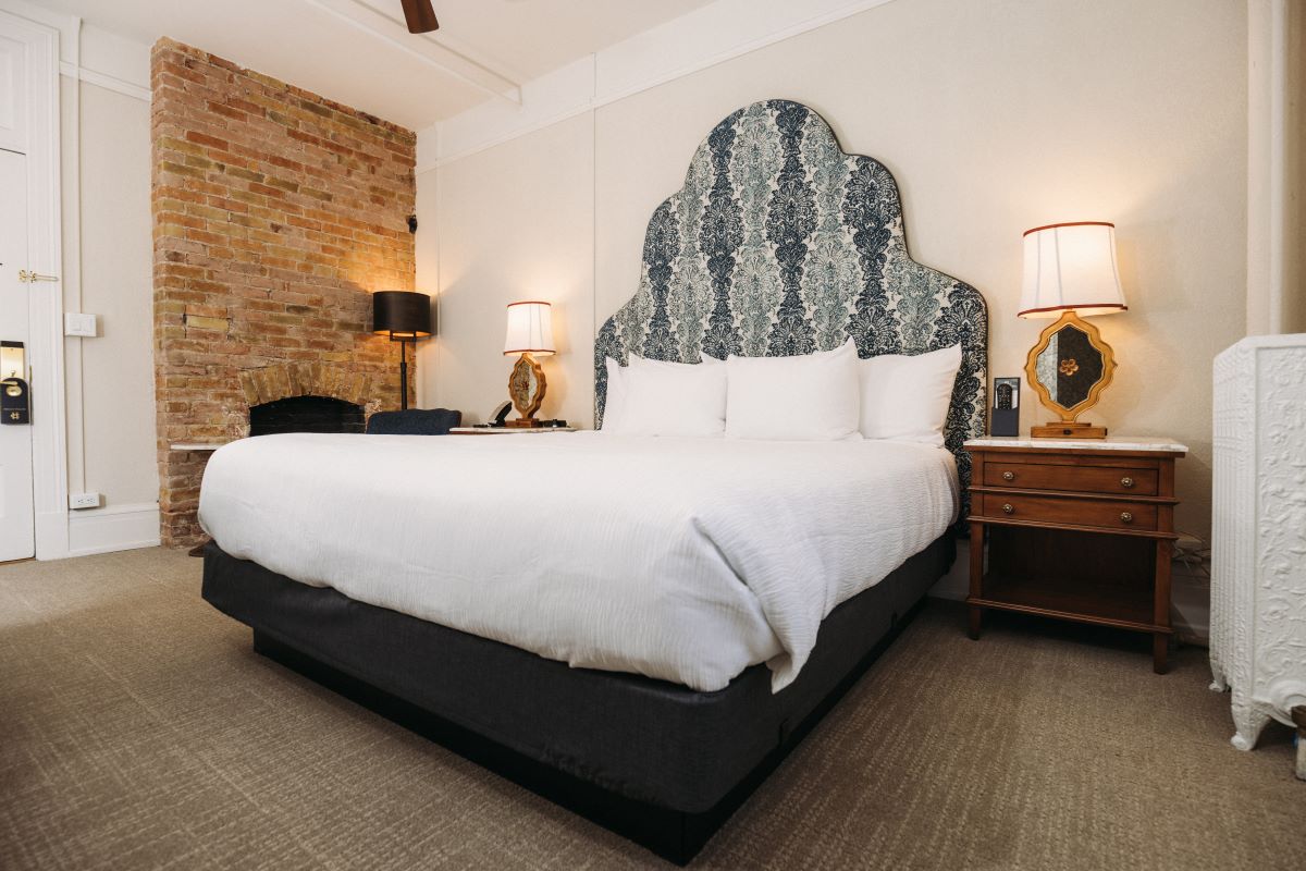 a bed with a fireplace and lamps