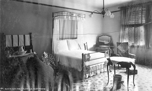 a bedroom with a bed and a mirror