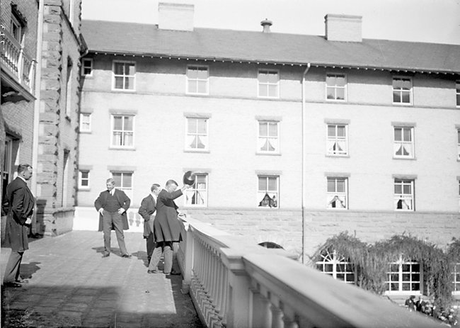 a group of men walking on a bridge