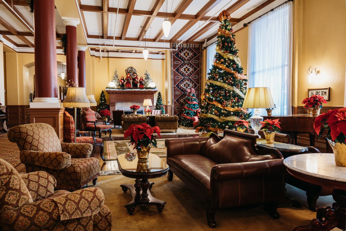 a living room with a christmas tree and a fireplace