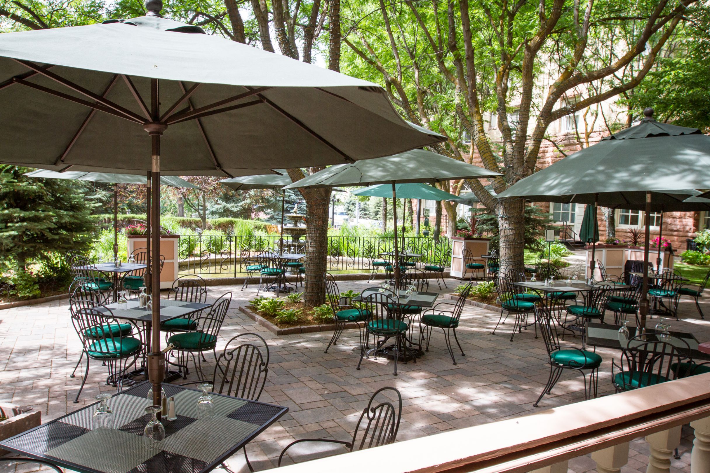 a patio with tables and umbrellas
