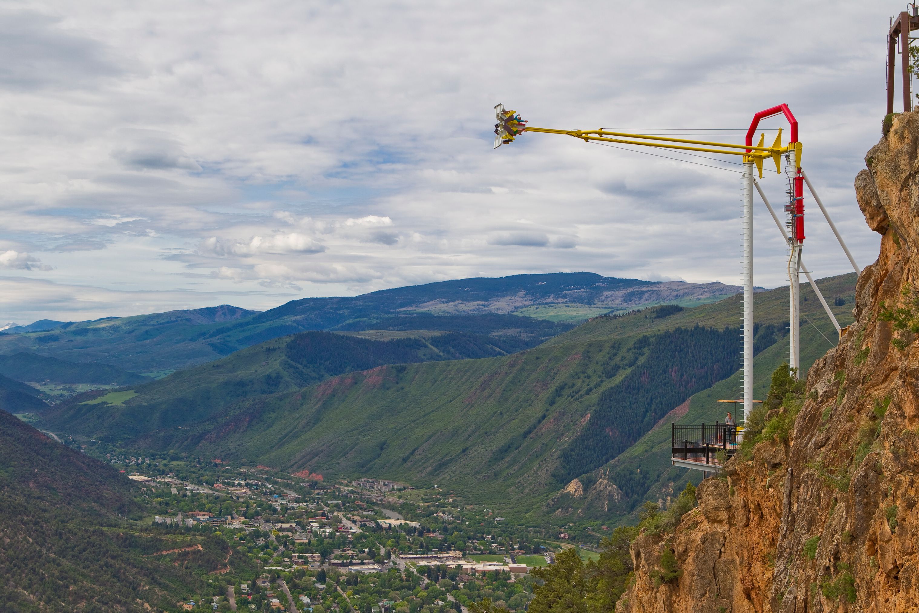 a yellow object on a pole above a valley