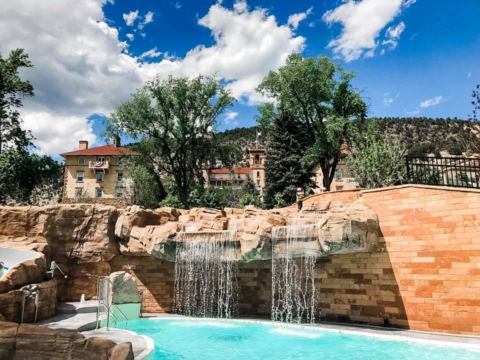 a pool with a waterfall over it