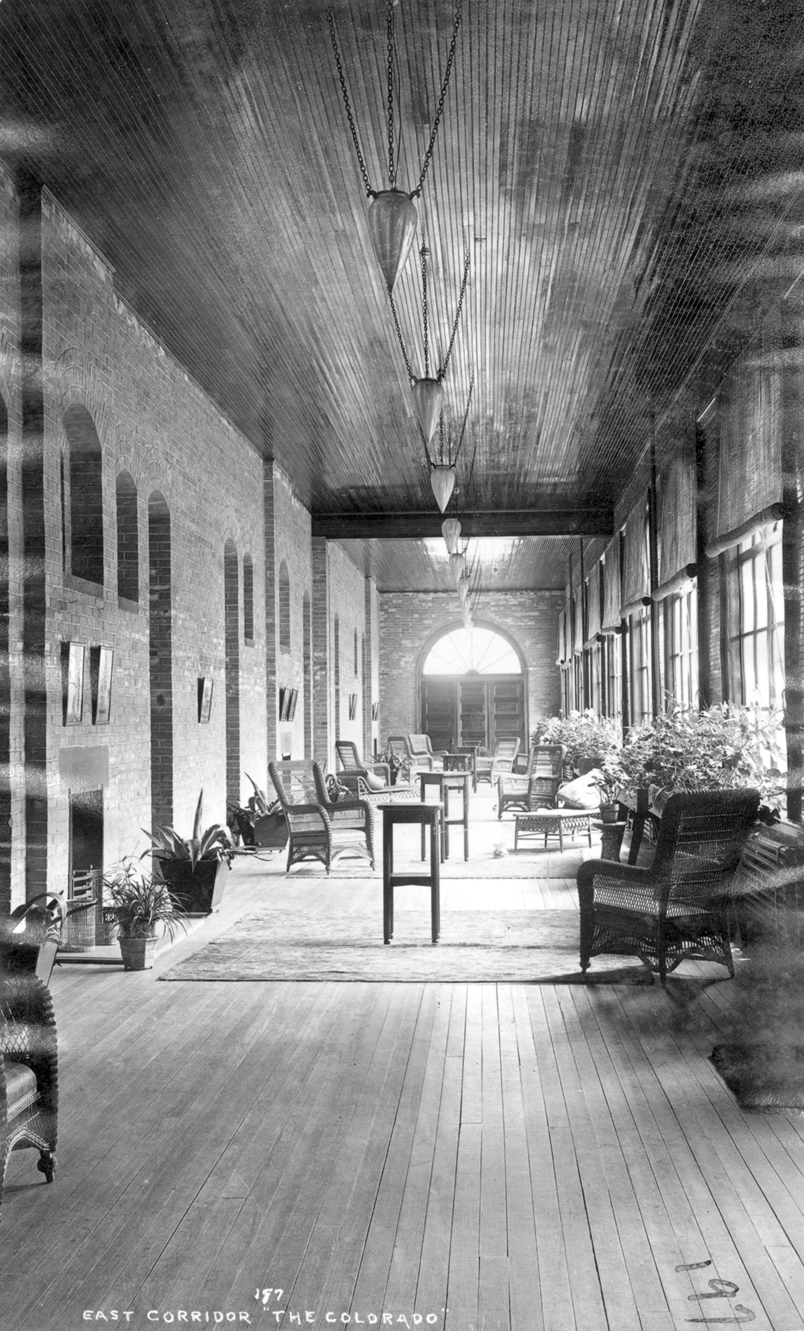 a long room with chairs and a rug
