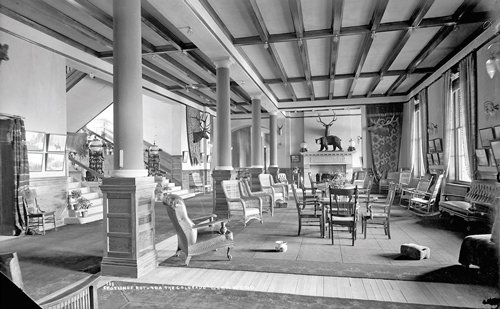 a room with chairs and a fireplace