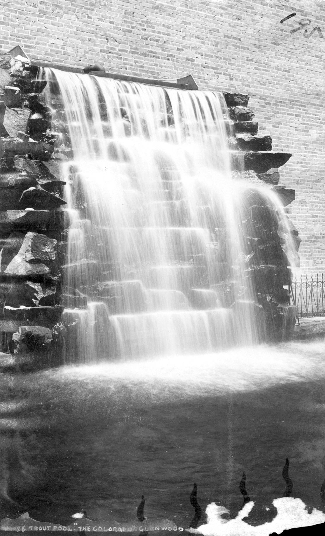 a waterfall over a stone wall