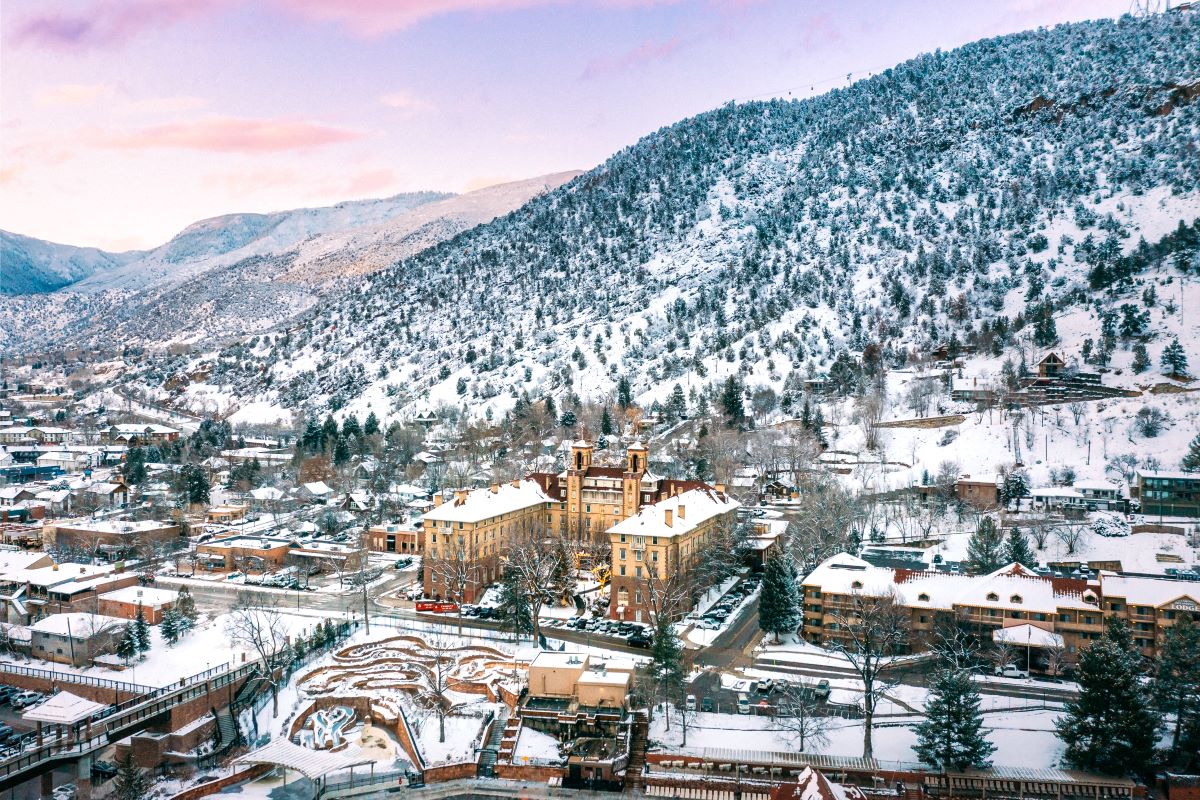 a snowy town with a mountain in the background