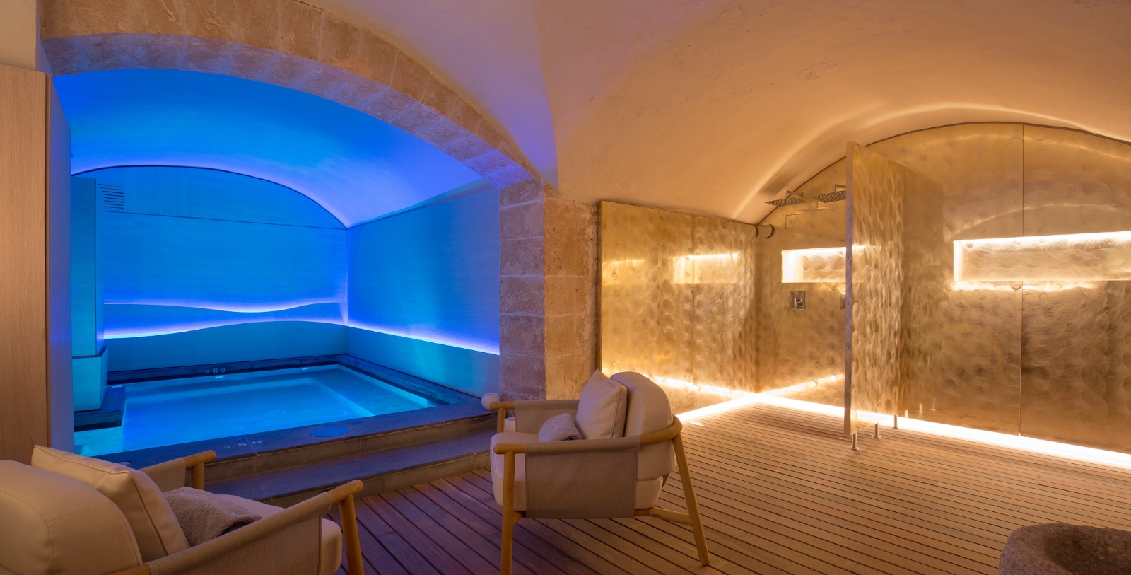 a room with a pool and chairs