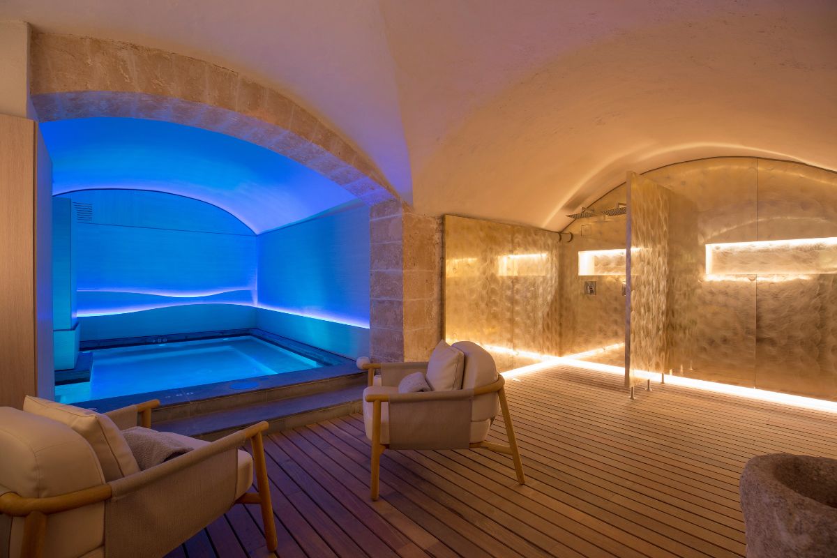 a room with a pool and chairs