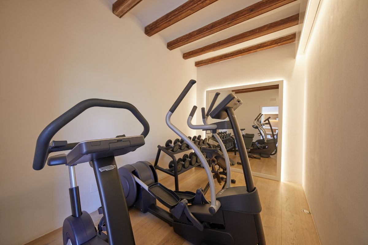 a room with exercise machines and a mirror