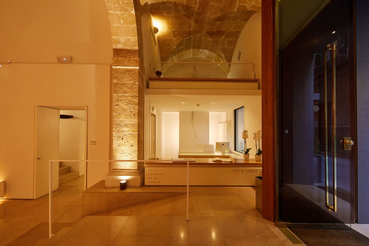 a room with a stone wall and a stone staircase