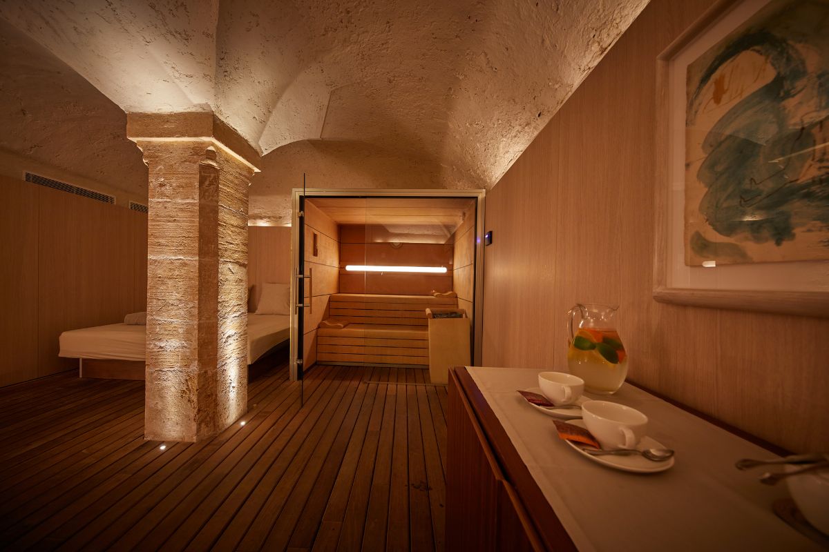 a room with a sauna and a table with tea cups and a glass jar