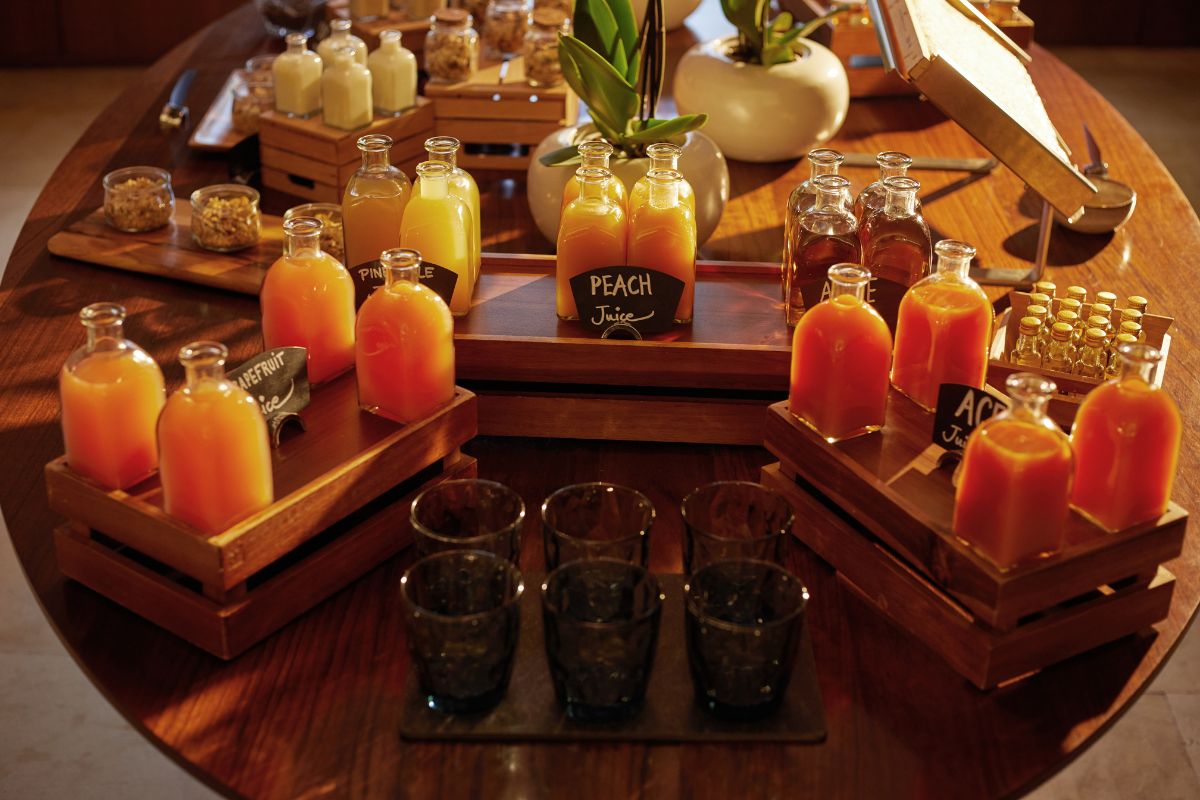 a table with bottles of juice and glasses