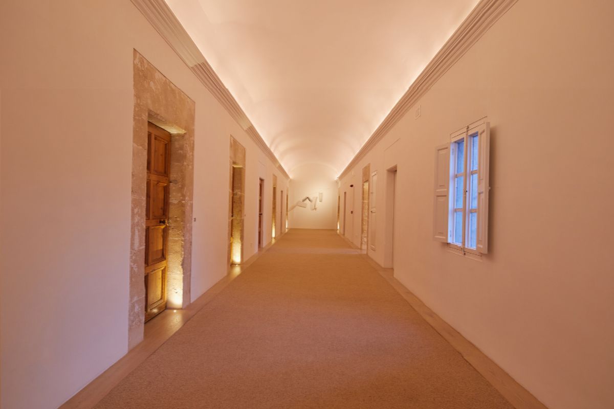 a long hallway with a light on the ceiling