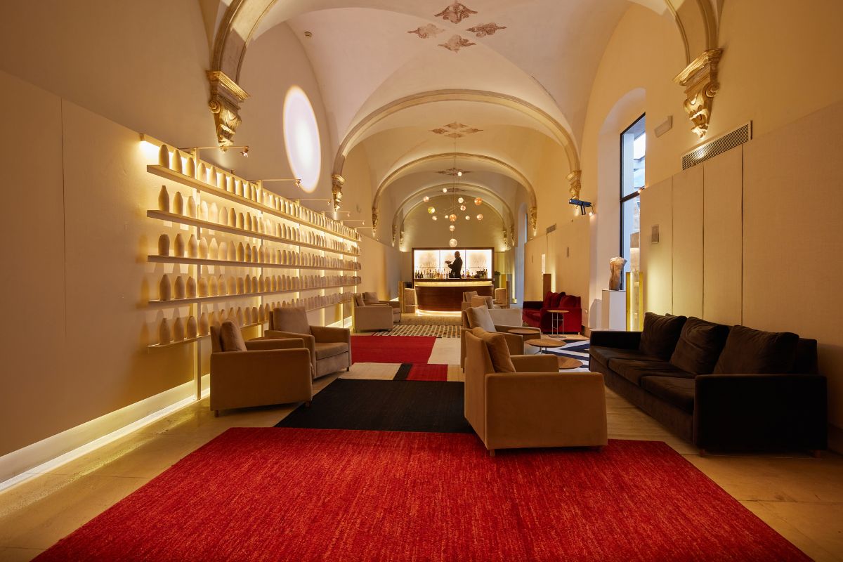 a room with a red rug and couches